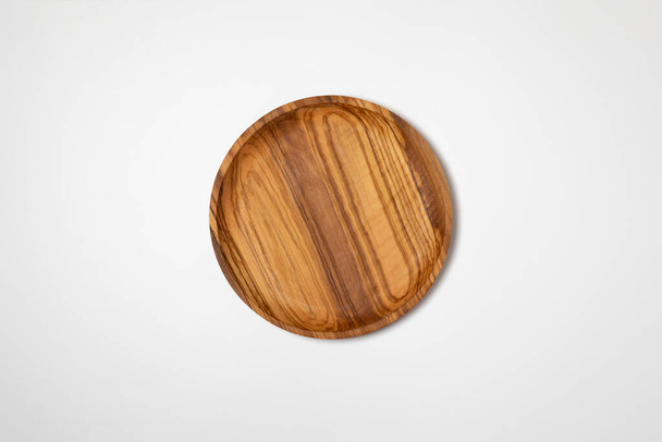 Wooden plate isolated on white background.High resolution photo.Top view. Mock-up.Wooden bowl. - Φωτογραφία, εικόνα