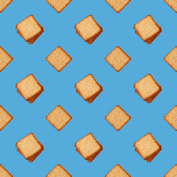 Square cookies on blue background seamless pattern - Photo, image