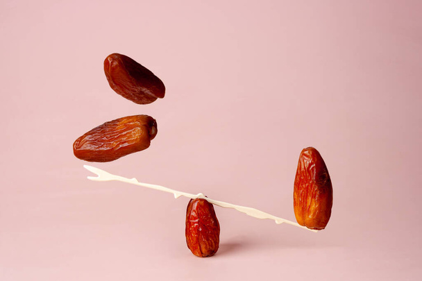 dried fruit dates on beige background flying food - Photo, Image