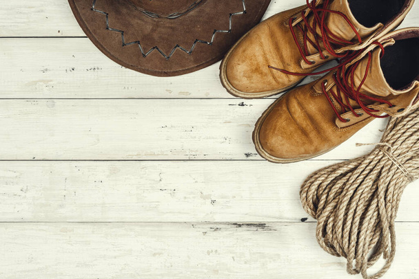 Hiking boots with travel accessories on grunge background - Fotoğraf, Görsel