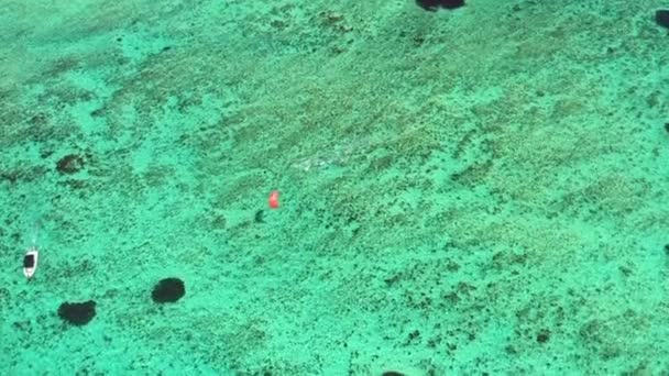 Aerial view of a kite surfer in the clear tropical water around Le Morne in Mauritius - Footage, Video