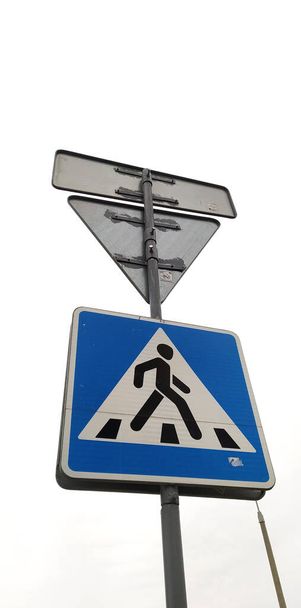 Moscow, Russia - April 26, 2020: Traffic lights on the street. The light is green. Pedestrians are allowed to cross the road. Pedestrian crossing sign. Vertical picture. - Фото, зображення