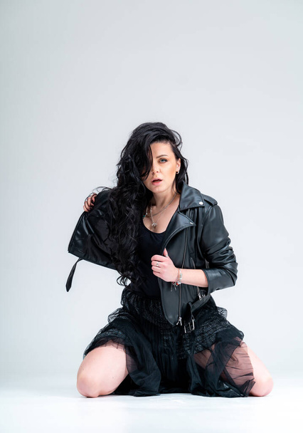 Beautiful attractive model posing for camera. Fashionable elegant woman in black jacket. - Foto, imagen