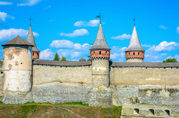 Photo of old ancient stone castle with many hight towers in Kamyanets-Podilsky - Zdjęcie, obraz