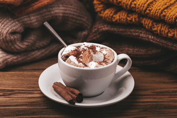 Cup of cacao and pile of knitwear - Foto, afbeelding