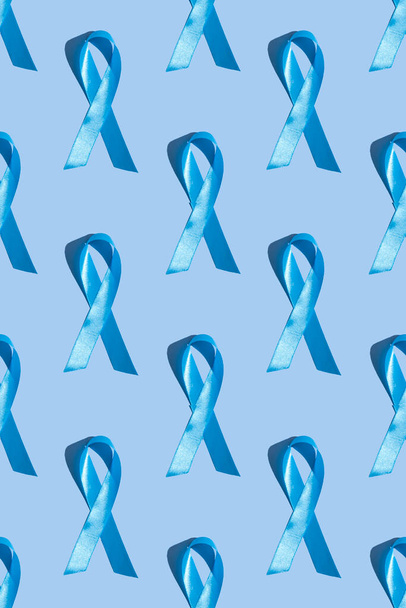 Concept for world diabetes day 14 november. Symbolic color bow to raise awareness on the day of diabetes on a light background. Seamless pattern.Vertical photo - Photo, Image
