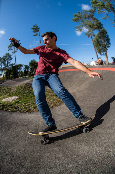 Skateboarder practice on a pump track park on a sunny day. - Фото, зображення