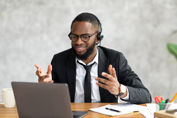 Black man having video call using laptop and talking - Photo, image