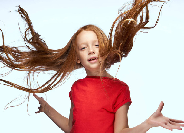 girl with red hair posing red t-shirt childhood - Fotoğraf, Görsel