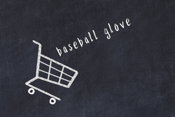 Chalk drawing of shopping cart and word baseball glove on black chalboard. Concept of globalization and mass consuming. - Photo, Image