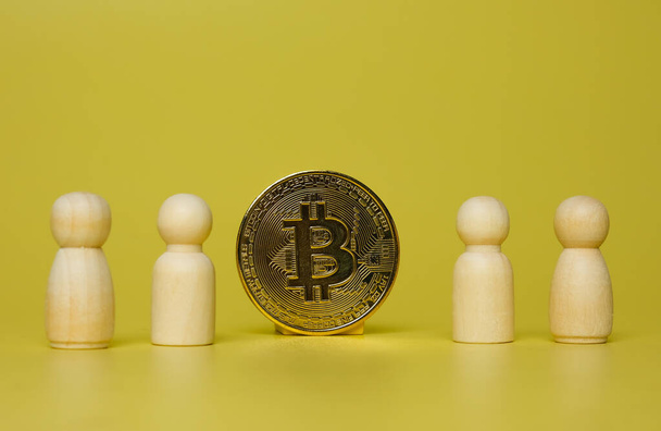 Selective focus of Bitcoin with peg dolls insight. Bitcoin and crypto currency education concept. - Foto, Imagen