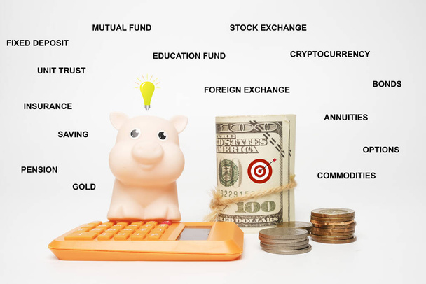 Uma imagem de porco, calculadora e dinheiro falso com a lista de tipo financeiro e de investimento que as pessoas normais podem fazer. - Foto, Imagem