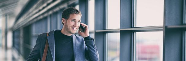 Business man talking on phone walking in airport using smartphone 5g tech device banner panorama - young businessman commute lifestyle panoramic background. - Photo, Image
