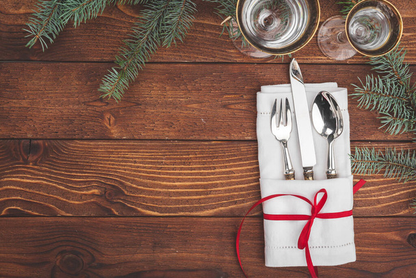 Christmas table setting with pine tree branches and decorations top view - 写真・画像