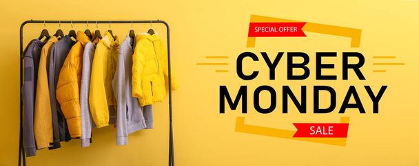 Rack with stylish clothes and text CYBER MONDAY on yellow background - Photo, image