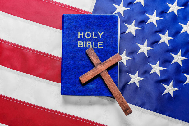 Holy Bible with wooden cross on flag of USA - Фото, изображение