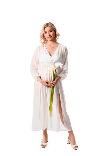 Young pregnant woman with calla lilies on white background - Φωτογραφία, εικόνα