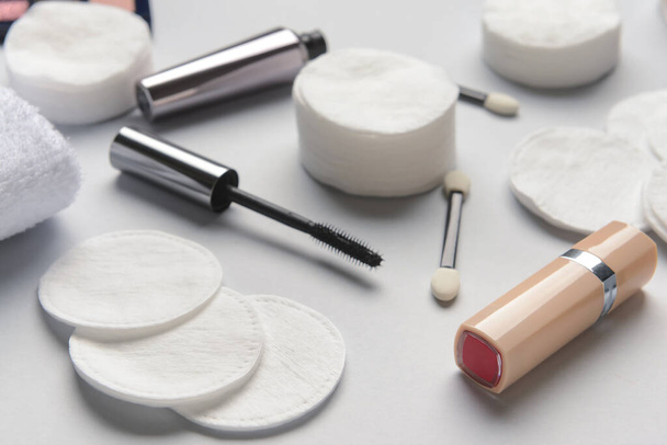 Clean cotton pads and cosmetics on light table, closeup - Photo, Image
