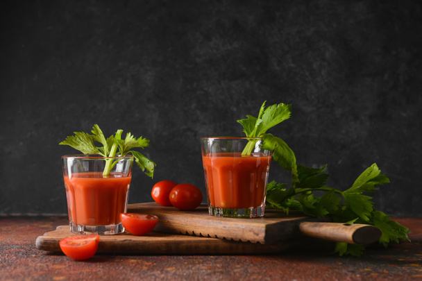 Glasses of bloody mary with celery and tomatoes on table - Fotoğraf, Görsel