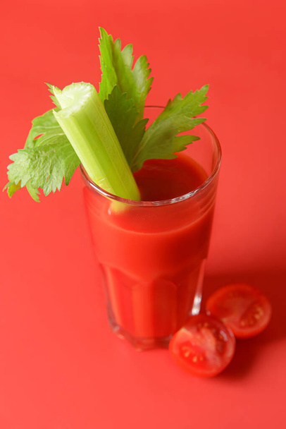 Glass of bloody mary with celery and tomatoes on color background - Photo, Image