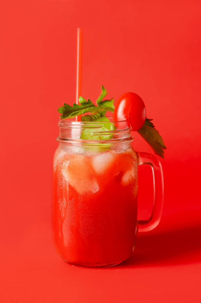 Mason jar of bloody mary with straw on color background - Photo, Image