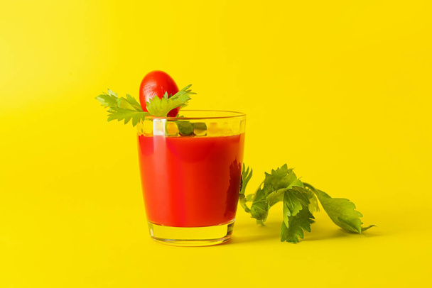 Glass of bloody mary with celery and tomato on color background - Photo, Image