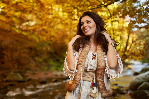 Portrait of a beautiful young woman by the river mid autumn - Foto, imagen