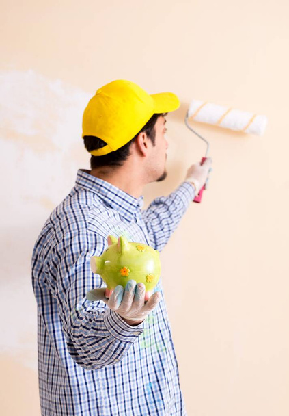 Painter man painting the wall at home - Φωτογραφία, εικόνα