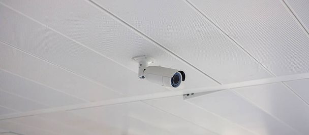 Moderne Überwachungskamera mit Büro- oder Haushintergrund, cctv zur Aufzeichnung und Objektschutz für den Parkplatz - Foto, Bild