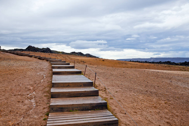 A set of stairs in the beautiful nature and landscapes in Iceland on a cloudy day - 写真・画像