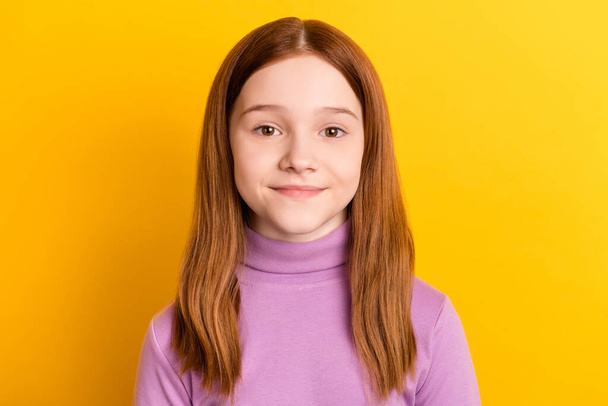 Close-up portrait of nice attractive red-haired girl schoolchild wearing lilac jumper isolated over bright yellow color background - Photo, Image