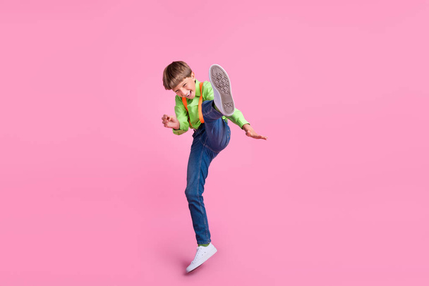 Full length body size view of attractive trendy funky boy jumping fooling fighting isolated over pink pastel color background - 写真・画像