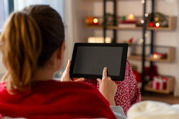 woman with tablet computer at home on christmas - 写真・画像