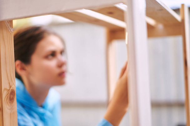 woman paints wooden objects painter decoration home renovation - Foto, Bild
