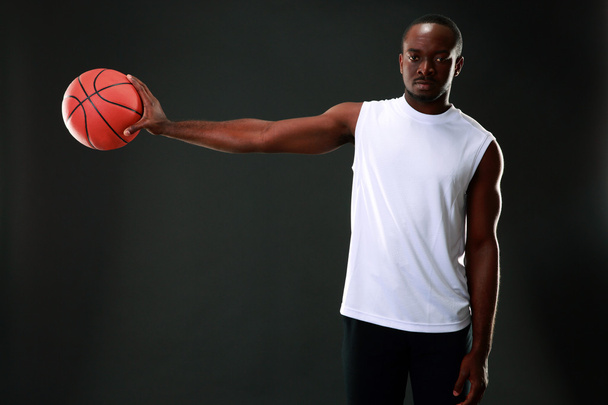Handsome sports african man over black background - Фото, изображение