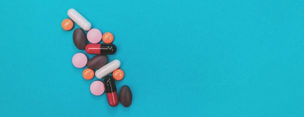 multicolored pills texture on blue panorama background - Фото, зображення
