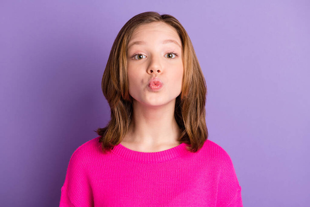 Photo of charming cute little girl send air kiss you wear pink pullover isolated on purple color background. - Fotoğraf, Görsel