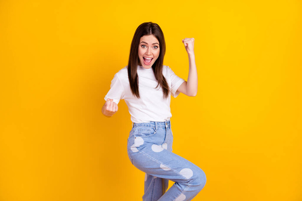 Photo of young happy excited crazy cheerful smiling woman raise fists in victory success isolated on yellow color background. - Fotoğraf, Görsel