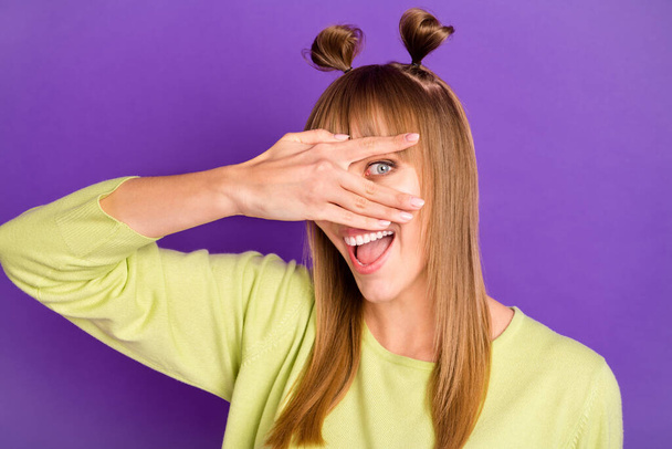 Photo of charming funky young woman dressed green pullover arm cover eye isolated purple color background - Foto, imagen