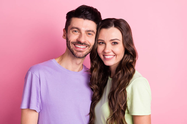 Portrait of attractive sweet cheerful couple embracing together forever isolated over pink pastel color background - Valokuva, kuva