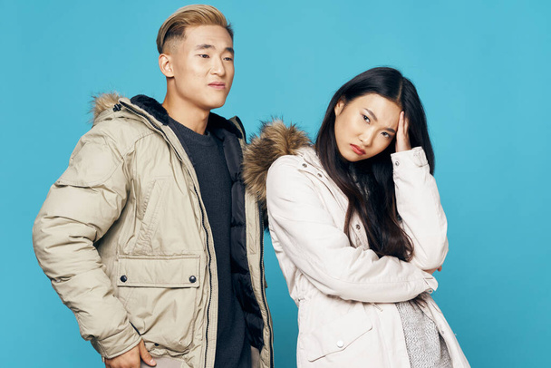 fashionable couple in winter clothes posing symphony modern style - 写真・画像