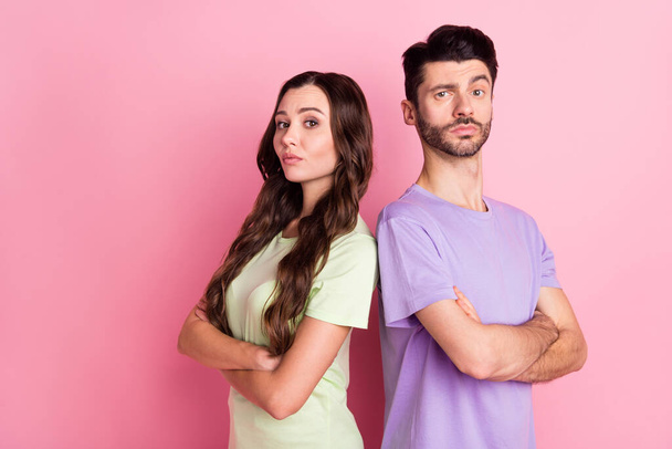 Profile side view portrait of attractive serious couple standing back to back folded arms isolated over pink pastel color background - Φωτογραφία, εικόνα
