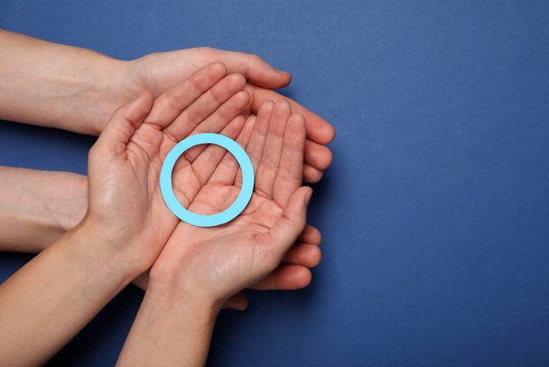 People showing blue paper circle as World Diabetes Day symbol on color background, top view with space for text - Foto, afbeelding