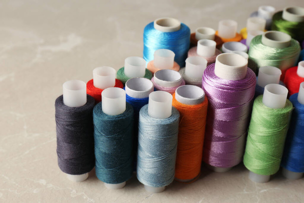 Set of color sewing threads on light grey table - Valokuva, kuva