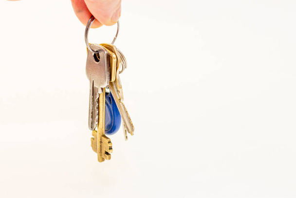 Man hold a Bunch of different flat keys isolated on the white background - Zdjęcie, obraz