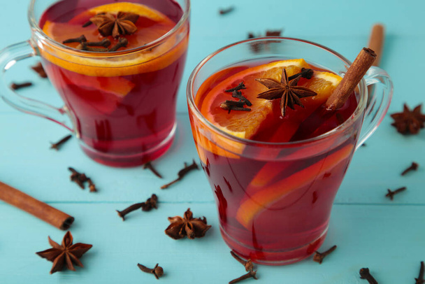Mulled wine with cinnamon and anise stars on blue background. Top view. - Fotografie, Obrázek