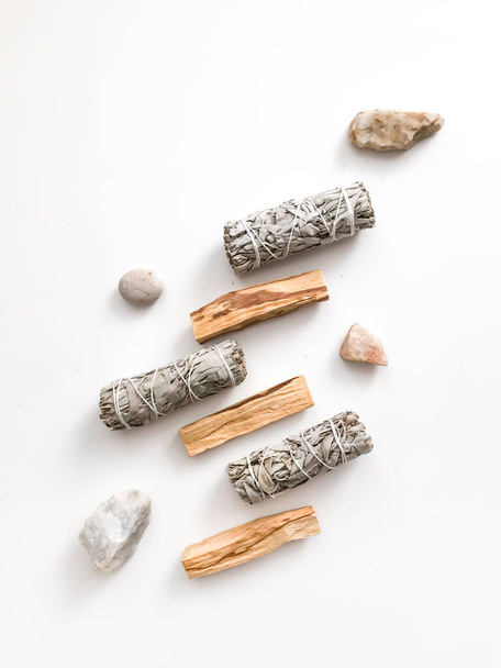 Bundle of dry white sage close-up. Product for purification, meditation and healing. Set of incense for fumigation of premises. Branches of white sage  on a white background. View from above. - Photo, Image