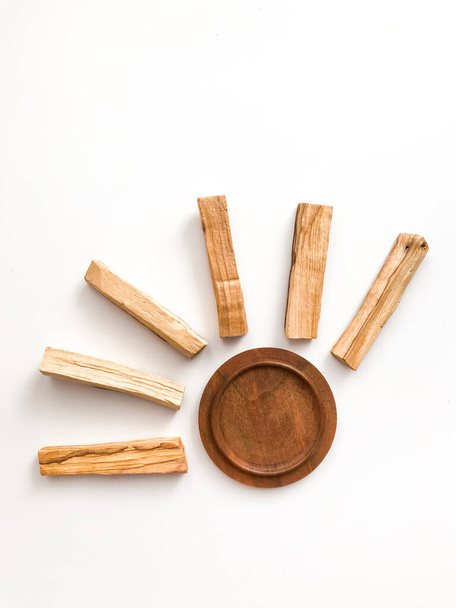 A set of wooden sticks Palo Santo on a white background. Aromatherapy and religious rites and meditations. Organic holy tree incense from Latin America top view - 写真・画像