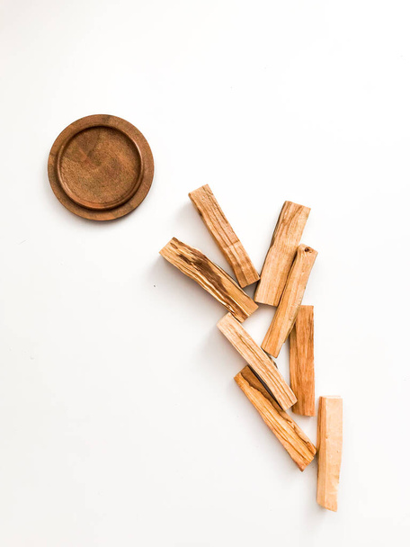 A set of wooden sticks Palo Santo on a white background. Aromatherapy and religious rites and meditations. Organic holy tree incense from Latin America top view - 写真・画像