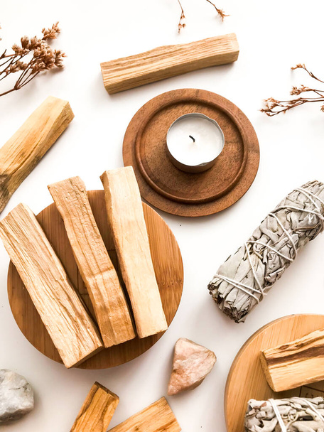 Natural incense White Sage and Palo Santo. Sacred tree of South America, color square photo.White Sage and Palo Santo on white background.  - Photo, Image
